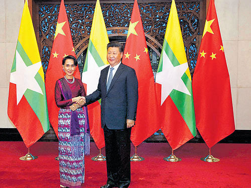 seeking friendly ties: Myanmar's State Counselor Aung San Suu Kyi and Chinese President Xi Jinping at the Diaoyutai State  Guesthouse in Beijing. The visit which ended on Sunday is Suu Kyi's first to China since her party won a historic majority last year. PTI