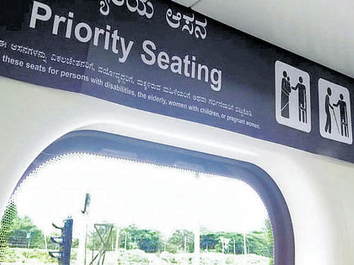 A 'Priority seating' poster inside the metro.