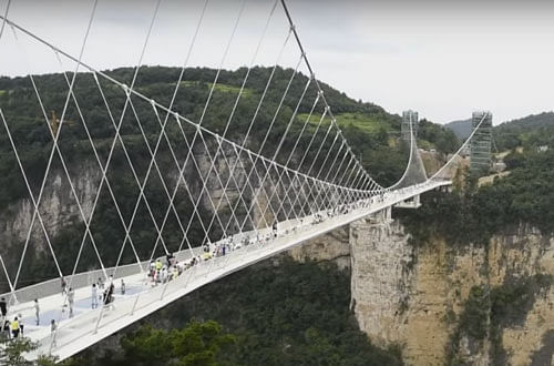 Some 430 metres (1,400 feet) long and suspended 300 metres above the earth, the bridge spans the canyon between two mountain cliffs in Zhangjiajie park in China's central Hunan province. Video grab