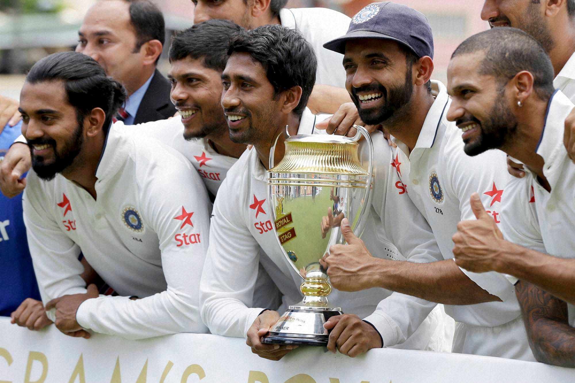 Indian cricketers, from left to right, Lokesh Rahul, Umesh Yadav, Wriddhiman Saha, Ajinkya Rahane and Shikhar Dhawan celebrate with the trophy during the award ceremony for the Test match series Royal Stag Cup at the Queen's Park Oval in Port-of-Spain, Trinidad, Monday, Aug. 22, 2016. India beat West Indies 2-0 in the series. AP/PTI