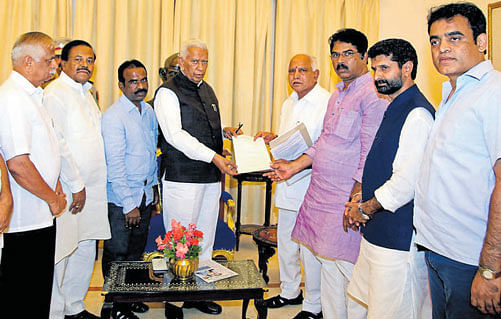 State BJP president B S Yeddyurappa and other leaders of the party submit a memorandum to Governor Vajubhai Vala. DH Photo