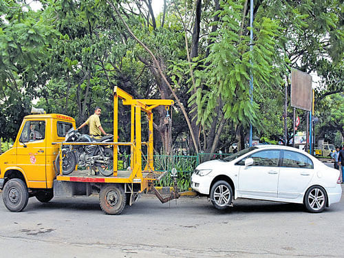 A file picture of police towing a wrongly parked car away.