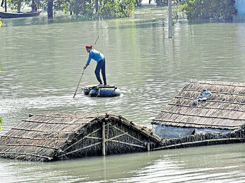 A man uses a tube boat to wade through a flooded area in Hajipur, Bihar on Tuesday. PTI