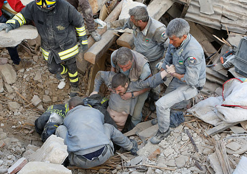 A man is rescued alive from the ruins following an earthquake in Amatrice, central Italy, August 24, 2016. REUTERS