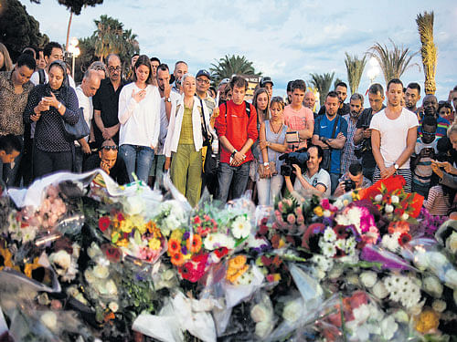 acts of courage: In this file photo, people bring flowers to the site of a terrorist attack in Nice, France on July 15. Some ordinary people in France have reacted heroically, risking their lives by fighting terrorists when they found themselves in the midst of an attack. nyt