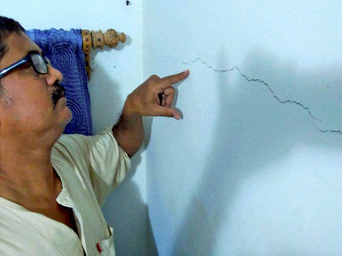 A man shows cracks on a wall after the earthquake at Balurghat in South Dinajpur district of West Bengal on Wednesday. PTI Photo