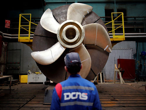 An employee looks at the propeller of a Scorpene submarine at the industrial site. Reuters File Photo.