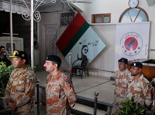Paramilitary officers stand guard after sealing the offices of the Muttahida Qaumi Movement, or MQM, in Karachi, Pakistan. Rueters Photo