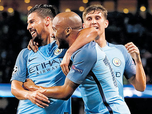 Routine: Manchester City's Fabian Delph (centre) celebrates with team-mates after scoring in his side's Champion's League play-off game against Steaua Bucharest. REUTERS