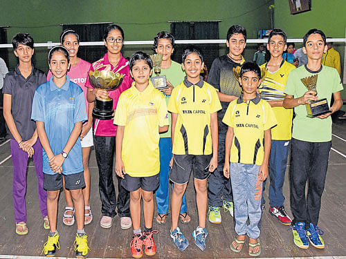 Champions: Winners at the Ramiah Rajan memorial State-level open badminton tournament at the Canara Union in Bengaluru. (From left, back row): Parichitha P and Ria Roy (girls' U-15 doubles), Roshni Venkat (girls' U-15 singles), Arya Hariharan (girls' U-13 singles), Suhas Venu and Chiranjeevi Reddy (boys' U-15 doubles). (Front row): Gayatri Rani Jaiswal and Karnika Sree(girls' U-13 doubles) Tushar S and Sumukh G S (boys U-13 doubles), Sujal Shekar (boys' U-13 singles). DH PHOTO