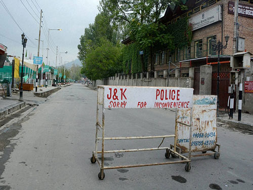Police puts barricades on lal chawk during curfew in Jammu and Kashmir on Thursday. PTI Photo