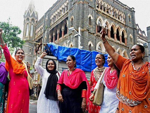 Bharatiya Muslim Mahila Andolan members celebrate after the Mumbai High Court has ruled that women can enter the inner sanctum of the Haji Ali Dargah in Mumbai on Friday. PTI Photo