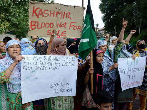Citizens hold placards and raise slogans to protest against the killing of civilians, in Srinagar on Friday. PTI Photo