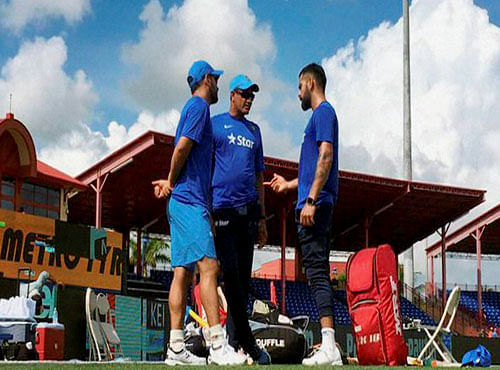 Captain Mahendra Singh Dhoni, vice-captain Virat Kohli and coach Anil Kumble chat ahead of the team's training session at Fort Lauderdale in Florida on Friday. Indian cricket team will be playing two T20 Internationals against West Indies for the first time in the United States. PTI Photo
