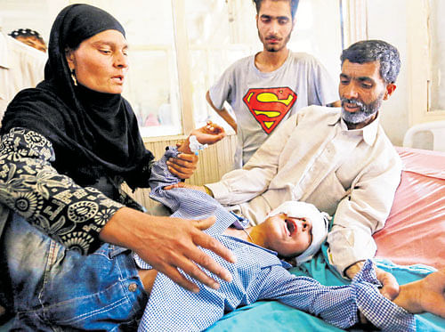 blinded future: Parents comfort their son who was injured by pellets shot by security forces following weeks of violence in Kashmir. Since mid-July, more than 570 patients have reported to Srinagar's main government hospital, with eyes ruptured by lead pellets. REUTERS