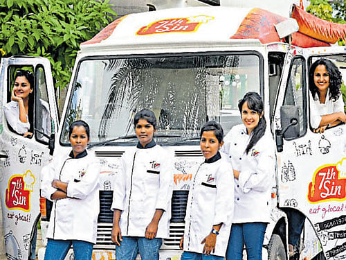 Archana Singh (extremeleft) the founder and Praveena Nandu, (extremeright) the CEO of Seventh Sin, with their food truck.