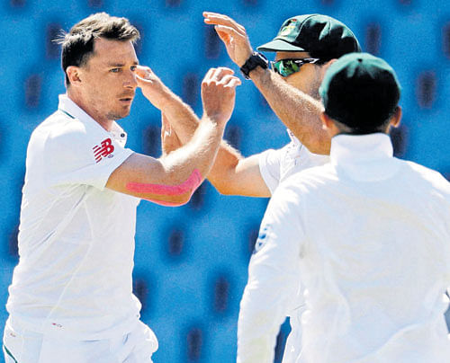 Wrecker-in-chief: South Africa's Dale Steyn (left) celebrates with team-mates after  dismissing Martin Guptill of New Zealand on the fourth day at Centurion on Tuesday. AP/ PTI