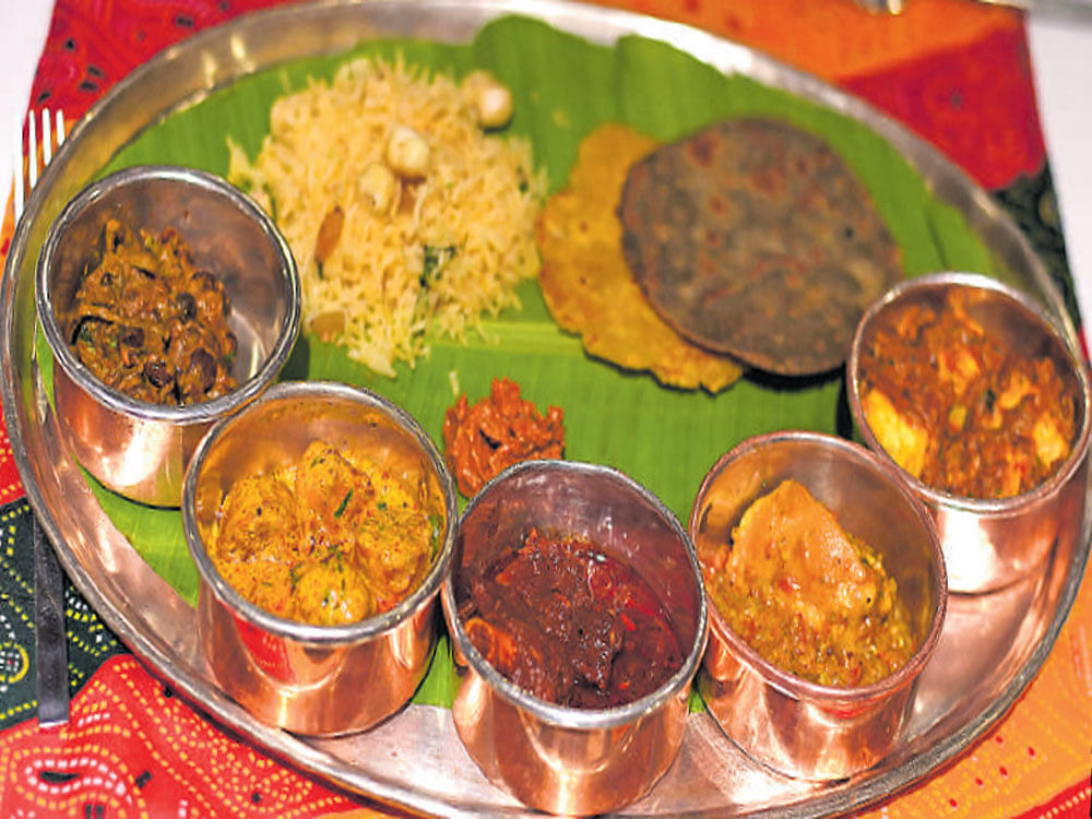 A traditional 'thaali' includes dishes like 'Panckotta ka saag', 'Murgh bajre ka soweta', 'Laal maas' along with 'bajre ki roti' and 'pulao'. For those with a sweet tooth, there is an array of options like two types of 'Ghewar', 'Malai ki burfi' and more.