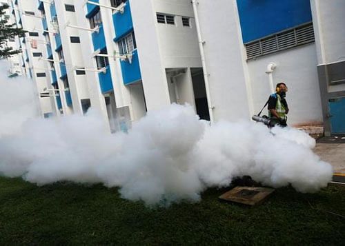 A worker fogs the drains in the common areas of a public housing estate at an area where locally transmitted Zika cases were discovered in Singapore August 31, 2016. REUTERS