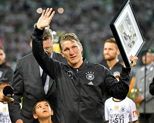 Emotional: Germany's Bastian Schweinsteiger waves to supporters during a farewell ceremony prior a friendly soccer match between Germany and Finland in Moenchengladbach, Germany, Wednesday. AP/PTI
