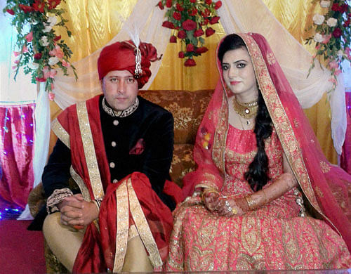 A sub inspector in Jammu and Kashmir Police with his bride from Pakistan-occupied Kashmir at their wedding function in Srinagar on Friday. PTI Photo