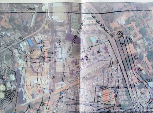 The village map superimposed on Google Earth image shows a stormwater drain running in the middle of the mall.