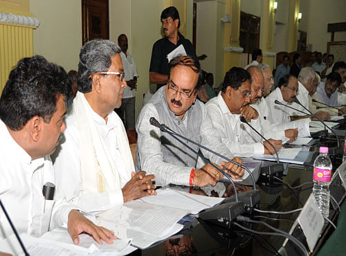 Chief minister Siddaramaiah having a word with member of parliment H N Ananth Kumar as water resoursers minister M B patil, ministers Dr. G Parameswara, T B Jayachandra, kagodu Thimmappa, member of parliments M Veerappa Moily, B S Yeddurappa and others looks on at the floor leaders meeting on Cauvery water issue at Vidhanasoudha conference hall in Bengaluru on Tuesday. DH photo