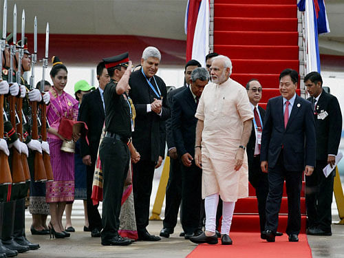 Prime Minister Narendra Modi is received upon his arrival at Vientiane International airport in Laos on Wednesday. PTI Photo