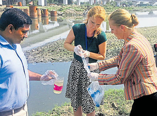 Scientists collect samples from the Barapullah drain.
