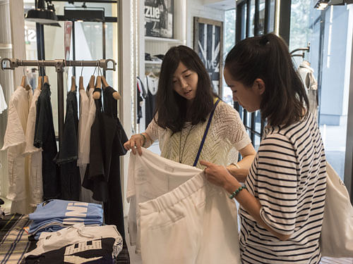In search of love: Wu Jingjing, 29 (left) shops with a friend in Beijing. Wu, who is single and works at an internet company, said young people in China no longer just want someone to marry, they want a relationship based on love. NYT