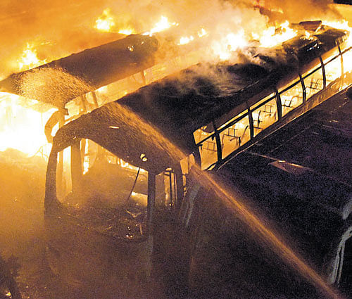 KPN travel buses set afire near Nayandahalli on Monday.  dh phot0/ B K Janardhan