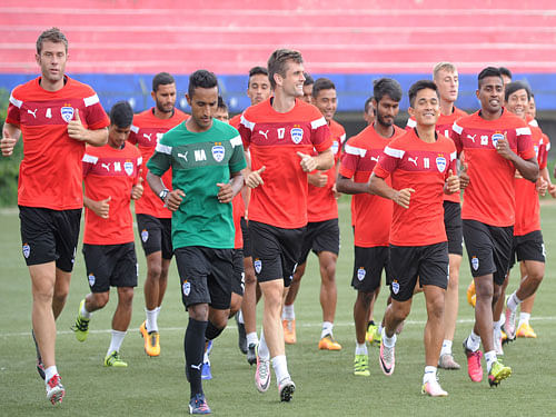 BFC captain Sunil Chhetri (4th from right) warm-up during the practice session at football stadium on the eve of the AFC Cup quarterfinal between Bengaluru FC and Tampines Rovers (Singapore) at Sree Kanteerava Stadium in Bengaluru on Tuesday. DH Photo.
