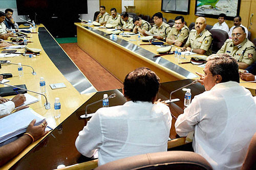 Karnataka Chief Minister Siddaramiah and State Home Minister G Parameshwara holding a meeting with top police officials in Bengaluru on Tuesday a day after violent protests over Cauvery water issue. PTI Photo