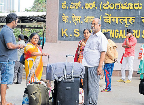 Passengers wait for an autorickshaw at the city railway  station on Tuesday. DH photo
