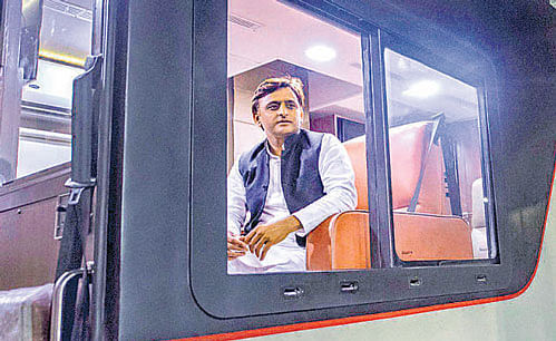 Chief Minister Akhilesh Yadav looks from the window of a bus on Wednesday. PTI