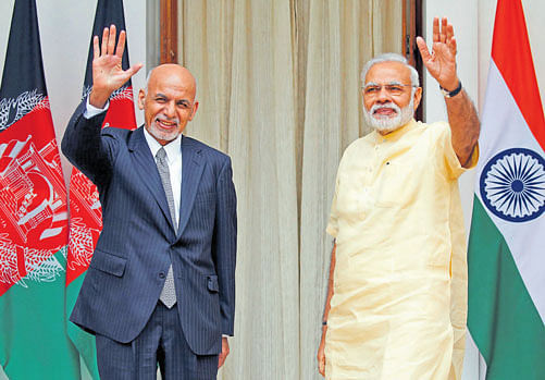 enhanced partnership: Afghan President Ashraf Ghani and Prime Minister Narendra Modi wave to the media outside  the Hyderabad House in New Delhi on Wednesday. REUTERS
