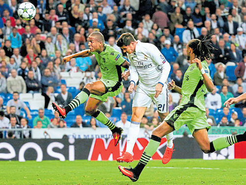 vital strike: Real Madrid's Alvaro Morata heads in the winner against Sporting Lisbon in their Champions League tie. REUTERS