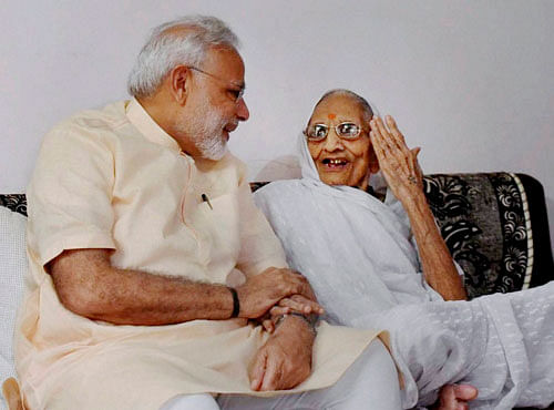 Prime Minister Narendra Modi interacts with his mother on his birthday, in Gandhinagar on Saturday. PTI