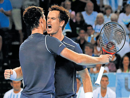gritty performance Great Britain's Andy Murray (right) celebrates with his brother Jamie after the duo beat Argentina in the doubles rubber on Saturday. reuters