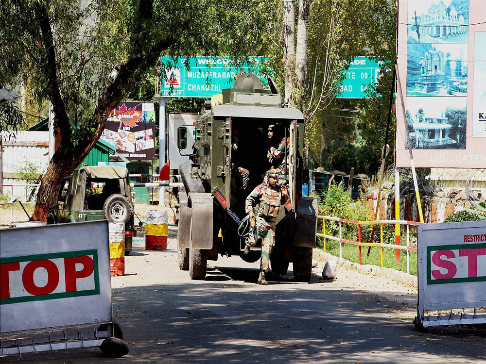 Army personnel in action inside the Army Brigade camp during a terror attack in Uri, Jammu and Kashmir on Sunday. PTI Photo