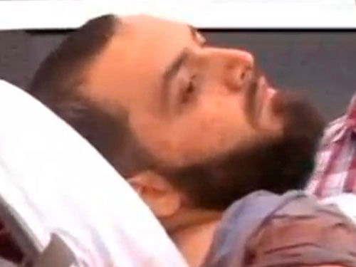 A still image captured from a video from WABC television shows a conscious man believed to be New York bombing suspect Ahmad Khan Rahami being loaded into an ambulance after a shoot-out with police in Linden. Reuters Photo.