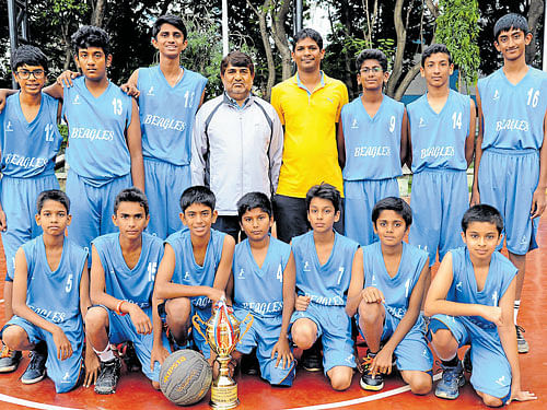 Beagles Basketball Club, winners of the boys' State Sub-junior basketball championship at the Sree Kanteerava Stadium in Bengaluru on Tuesday. STANDING (Fromleft): Navneeth, Kalyan, Achintya, Mohan (coach), Markesh (Manager), Divyesh, Dhruv V and Surya Shashank. KNEELING: Athishay, Likith, Himanshu, Anirudh, Dhruv P, Vedanth and Hayagreeve. Beagles defeated YMMA in the title round to emerge champions. DH PHOTO