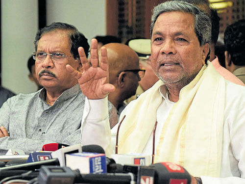 Chief Minister Siddaramaiah briefs the media at his official residence Cauvery in Bengaluru on Tuesday. Home Minister Dr G Parameshwara is also with him. DH Photo