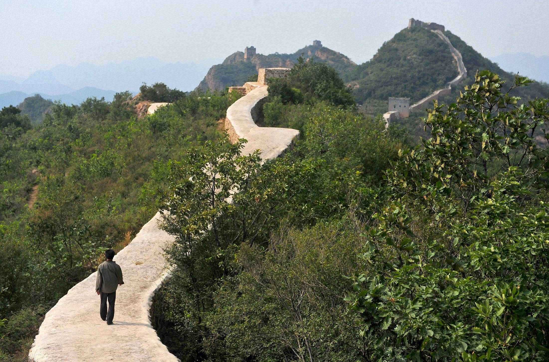 A villager walks across a restored section of the Great Wall in Suizhong County in northeastern China's Liaoning Province. AP/PTI Photo