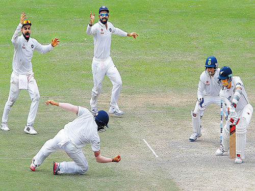smart catch: Rohit Sharma snaps a low offer from Trent Boult off Ravindra Jadeja (not seen in pic) on the third day of the first Test on Saturday. reuters