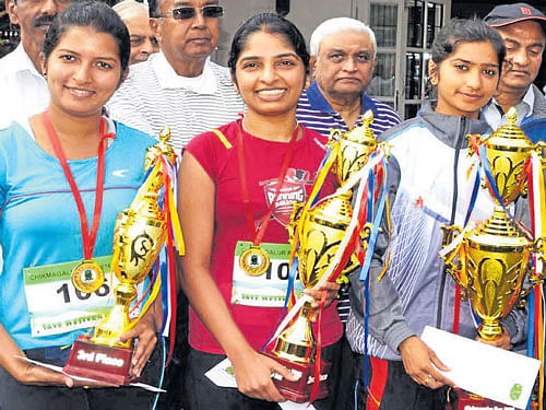 Winners: Top three finishers in the women's section of the State-level cross country race with their trophies. FROM LEFT: HJ&#8200;Ganavi (3rd), Priyanka Mallesh (2nd), Vandana (1st).
