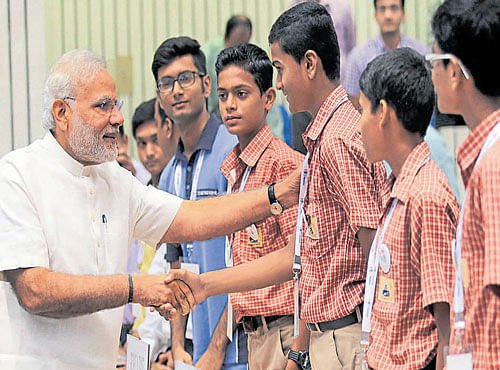 WITH YOUNG GUNS: Prime Minister Narendra Modi interacts with students who won the innovation award at the CSIR platinum jubilee in New Delhi on Monday. DH PHOTO