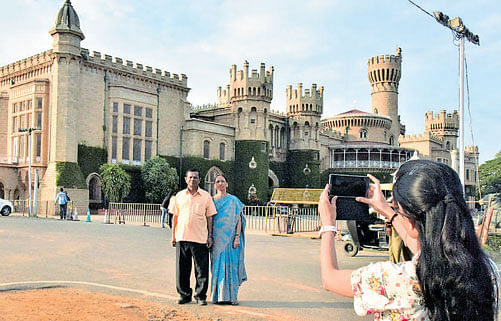 Visitors take a photo in front of the Bangalore Palace on the eve of the World Tourism Day on Monday. Dh Photo