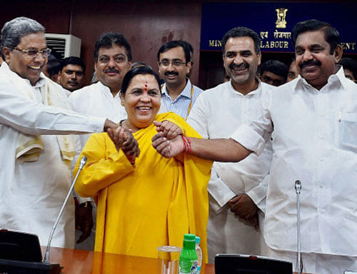 Union Minister for Water Resources, River Development and Ganga Rejuvenation, Uma Bharti during a meeting on Cauvery issue with the Chief Minister of Karnataka, Siddaramaiah and PWD Minister of Tamil Nadu, Edappadi K Palanisamy in New Delhi on Thursday. MoS for Water Resources, River Development and Ganga Rejuvenation, Sanjeev Kumar Balyan is also seen. PTI Photo