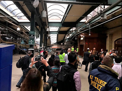 Onlookers view a New Jersey Transit train that derailed and crashed through the station in Hoboken. Reuters Photo.